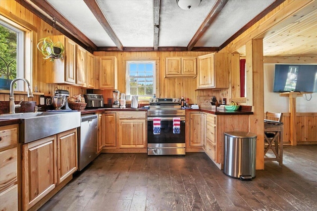 817 Riverside Dr, Augusta, ME 04330 - kitchen with appliances with stainless steel finishes, beam ceiling, wooden walls, dark wood-style flooring, and dark countertops