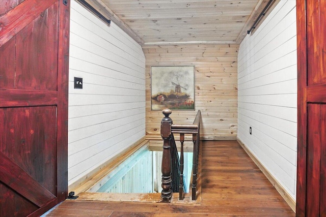 817 Riverside Dr, Augusta, ME 04330 - hallway with wood walls, wood finished floors, and wood ceiling