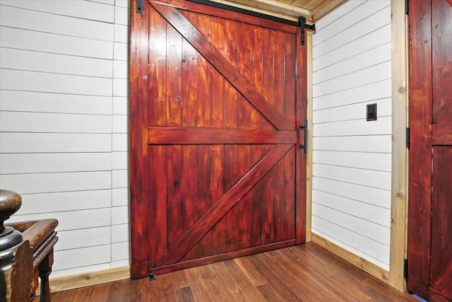 817 Riverside Dr, Augusta, ME 04330 - detailed view of a barn door, wood finished floors, and wood walls