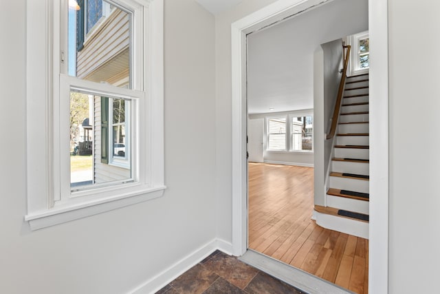 interior space featuring baseboards and stairway