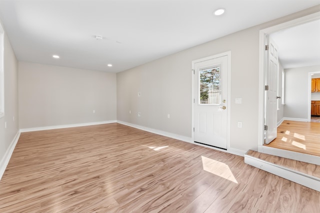 entryway with recessed lighting, baseboards, and light wood-style floors