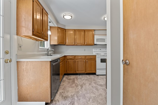 kitchen featuring white appliances, brown cabinets, a sink, and light countertops