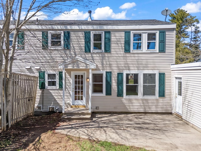 rear view of property featuring a patio area and fence
