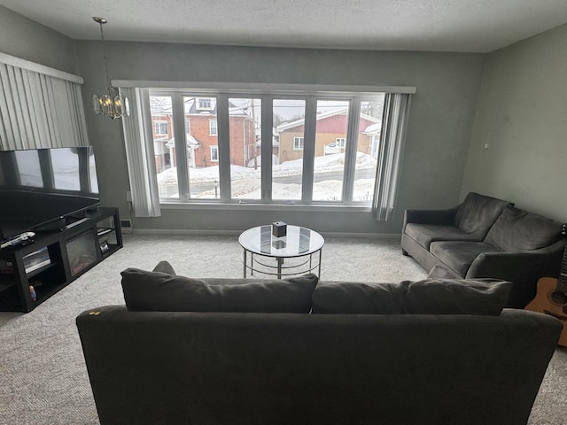 living area with carpet flooring, a chandelier, and a healthy amount of sunlight