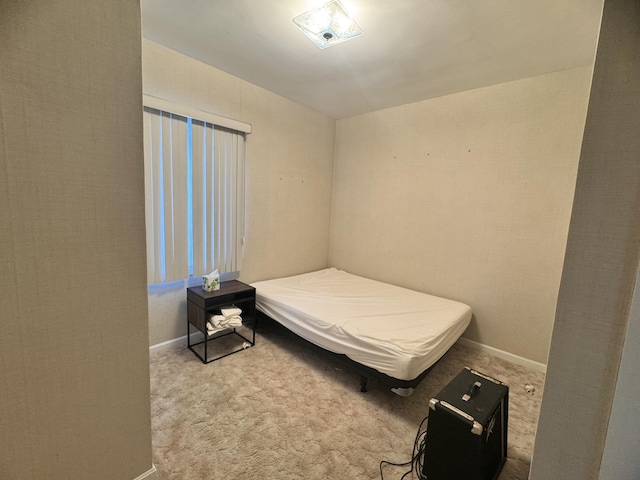 bedroom featuring baseboards and carpet flooring