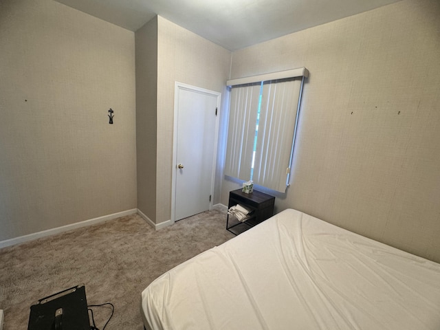 carpeted bedroom featuring baseboards
