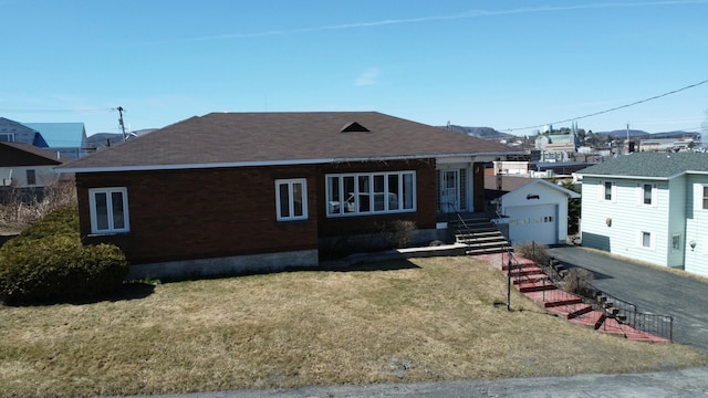 view of front of home with a garage, roof with shingles, an outdoor structure, and driveway
