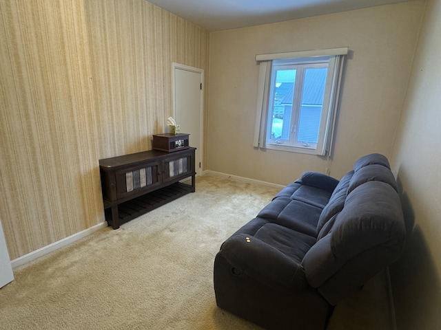 living area with wallpapered walls, baseboards, and carpet floors