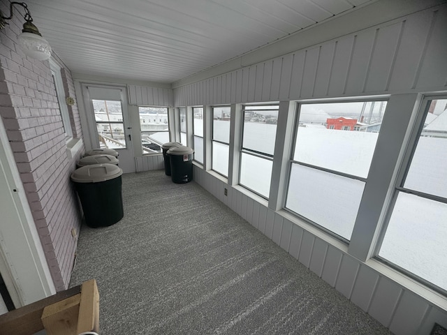 unfurnished sunroom with carpet