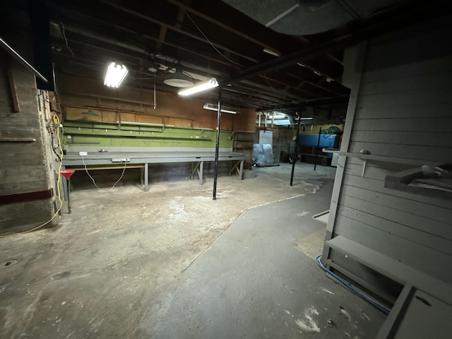 unfinished basement featuring water heater