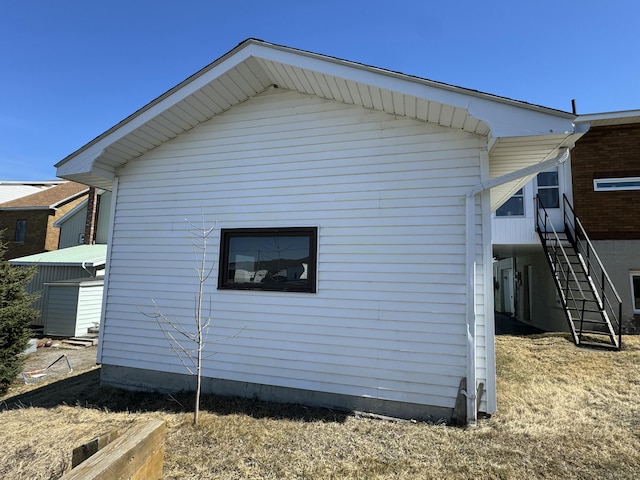view of side of property featuring stairs