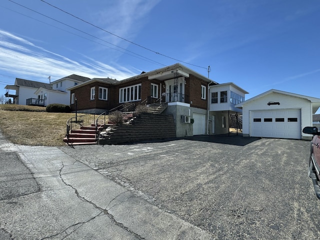 ranch-style house with stairway and driveway