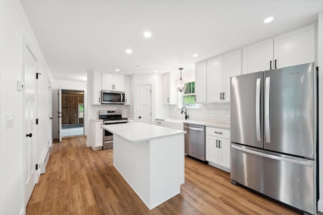 LOT87-1-2 Drown Rd, Alfred, ME 04002 - kitchen with stainless steel appliances, tasteful backsplash, white cabinetry, and a baseboard radiator
