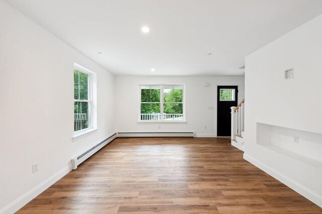 LOT87-1-2 Drown Rd, Alfred, ME 04002 - unfurnished living room with light wood-style floors, a baseboard radiator, and stairs