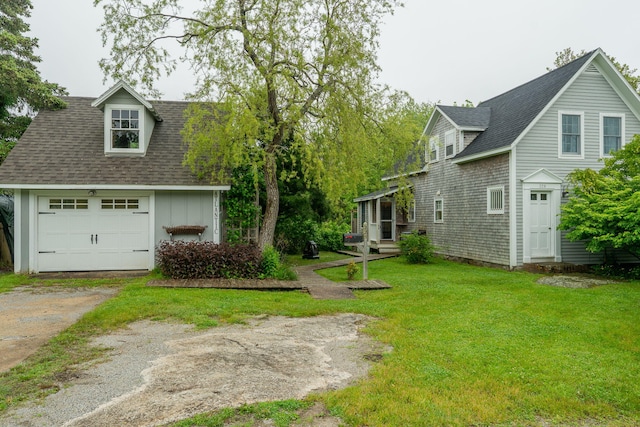 228 Atlantic Ave, Boothbay Harbor, ME 04538 - view of green lawn featuring driveway and a garage