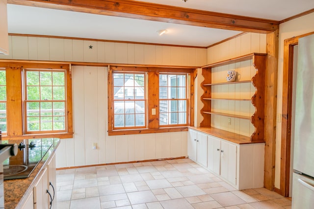 228 Atlantic Ave, Boothbay Harbor, ME 04538 - unfurnished dining area featuring healthy amount of natural light, crown molding, and wood walls