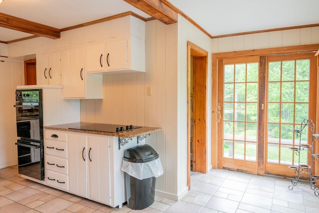 228 Atlantic Ave, Boothbay Harbor, ME 04538 - kitchen featuring black appliances, crown molding, white cabinetry, light tile patterned flooring, and dark stone countertops