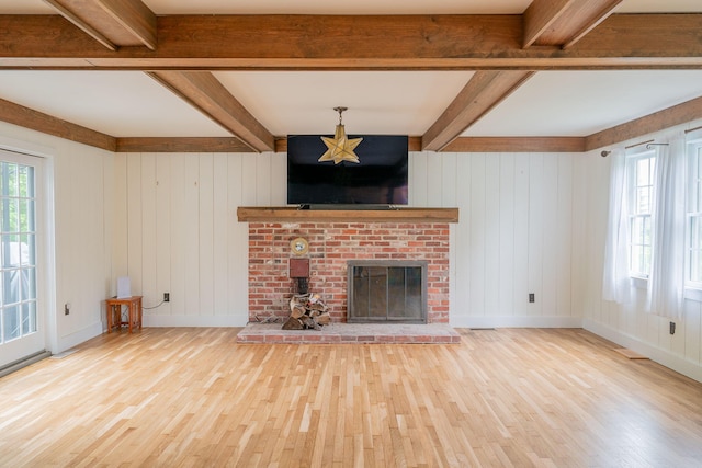 228 Atlantic Ave, Boothbay Harbor, ME 04538 - unfurnished living room featuring wood finished floors, a fireplace, and beamed ceiling