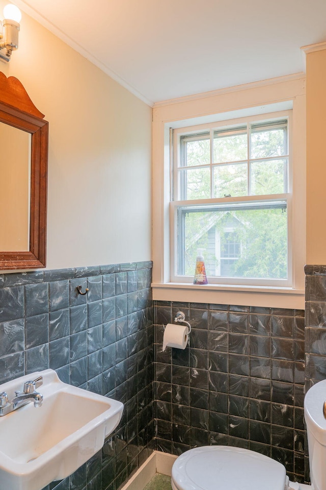 228 Atlantic Ave, Boothbay Harbor, ME 04538 - half bathroom with tile walls, ornamental molding, and a wainscoted wall