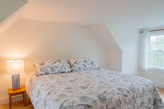 228 Atlantic Ave, Boothbay Harbor, ME 04538 - bedroom with lofted ceiling and wood finished floors