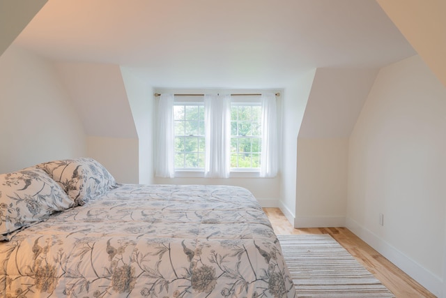 228 Atlantic Ave, Boothbay Harbor, ME 04538 - bedroom with vaulted ceiling and light wood-type flooring