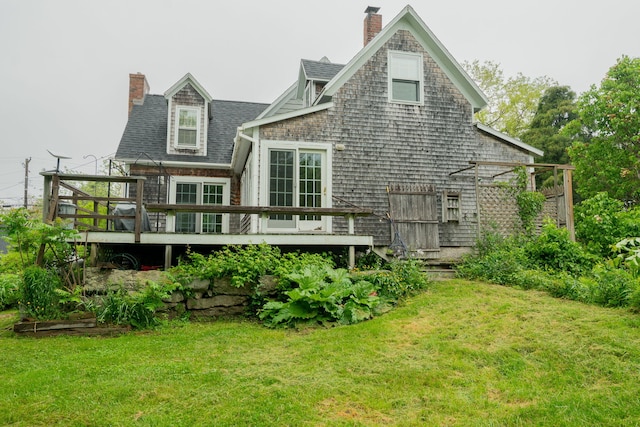228 Atlantic Ave, Boothbay Harbor, ME 04538 - back of house with a chimney, a lawn, and a deck