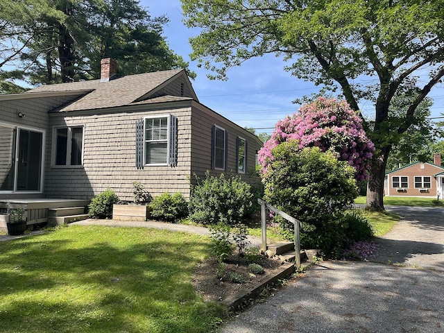 241 Berwick Rd, Ogunquit, ME 03907 - view of front of home featuring a front yard, a shingled roof, and a chimney