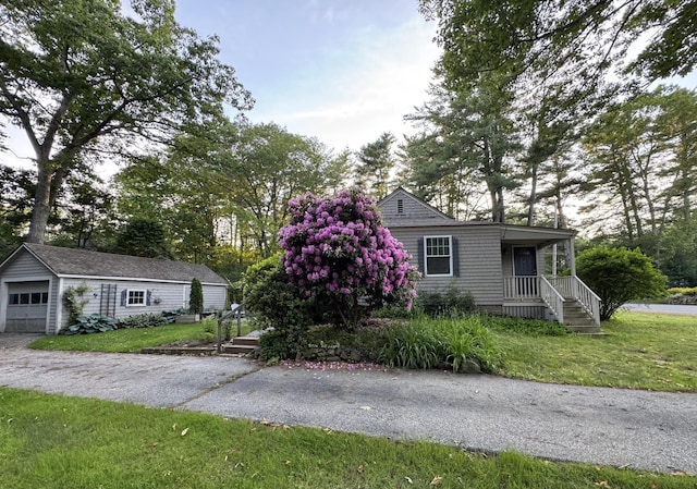 241 Berwick Rd, Ogunquit, ME 03907 - view of front facade with an outdoor structure, a front yard, and a garage