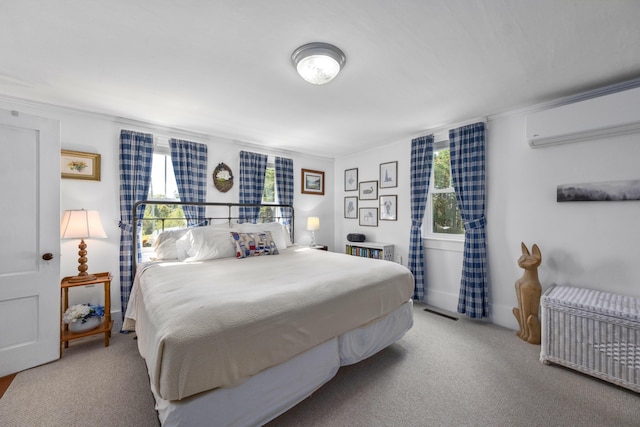 carpeted bedroom with a wall mounted air conditioner, visible vents, and multiple windows