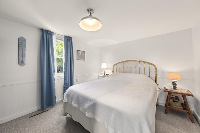 carpeted bedroom with baseboards and visible vents