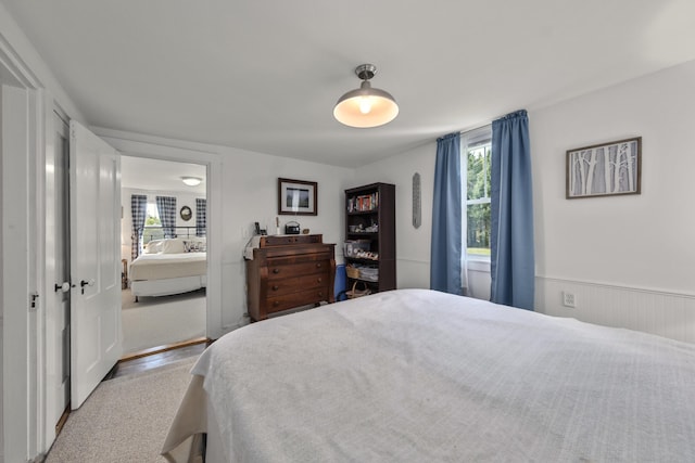 bedroom with ensuite bath and multiple windows