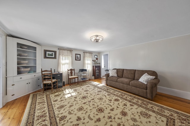 living room with a chandelier and light wood-style floors