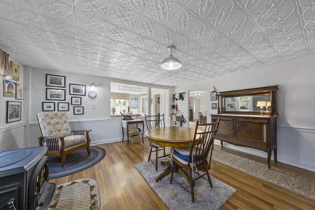 dining room with wood finished floors and an ornate ceiling