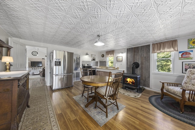 dining space featuring dark wood finished floors, an ornate ceiling, and a wealth of natural light
