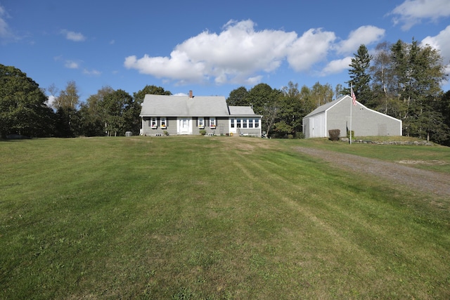 view of front of house featuring an outbuilding and a front yard