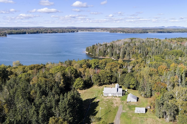 aerial view featuring a wooded view and a water view