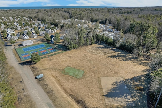 birds eye view of property with a wooded view