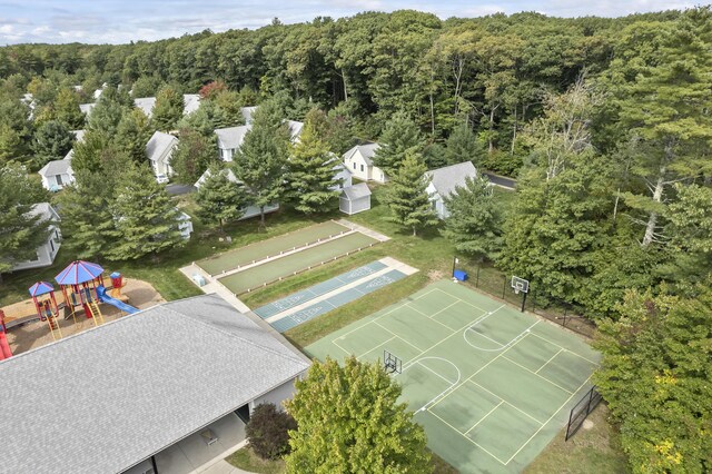 bird's eye view with a wooded view