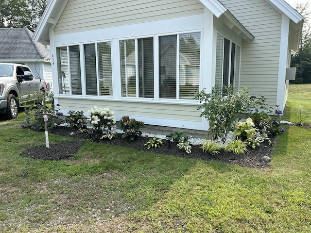view of property exterior with a yard