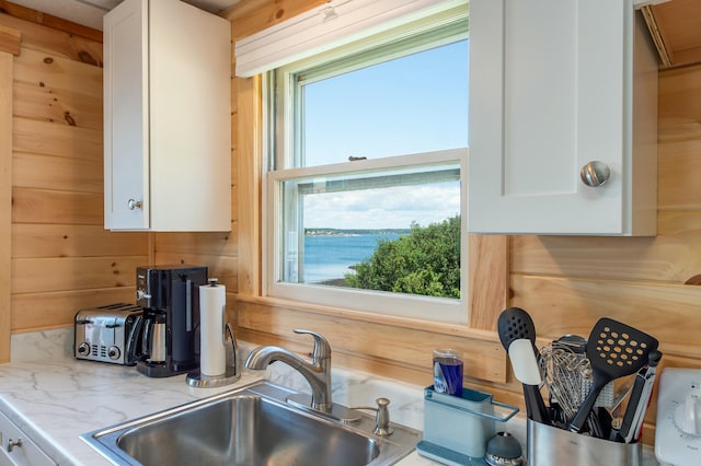 43 W Shore Rd, Harpswell, ME 04003 - kitchen featuring white cabinets, a sink, and light stone counters
