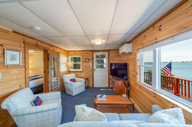 43 W Shore Rd, Harpswell, ME 04003 - carpeted living room featuring a wall mounted air conditioner, a wealth of natural light, wooden walls, and a paneled ceiling