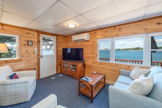 43 W Shore Rd, Harpswell, ME 04003 - carpeted living area with a wealth of natural light, wooden walls, a wall mounted AC, and a drop ceiling