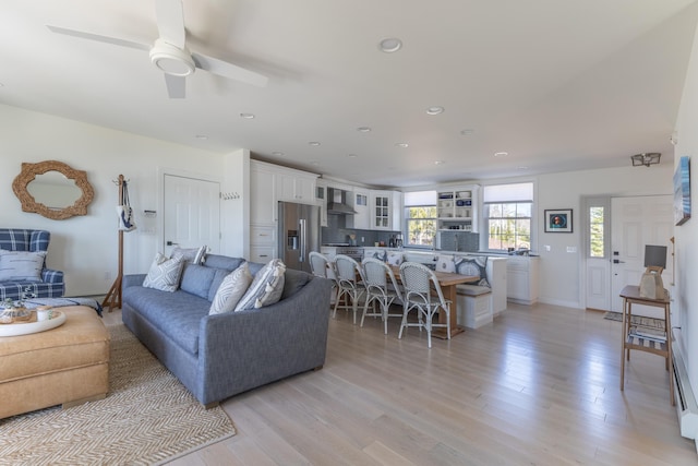 living room featuring recessed lighting, ceiling fan, and light wood finished floors
