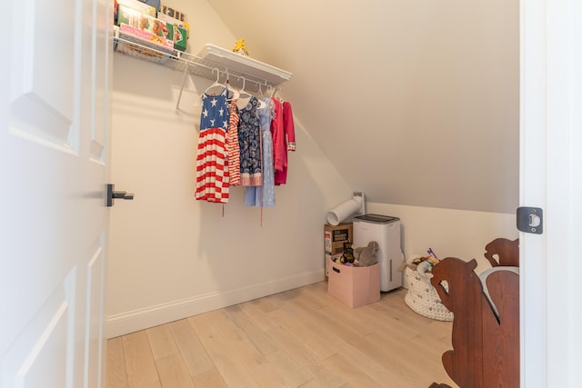 laundry room with baseboards and wood finished floors