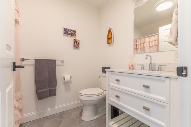 full bathroom featuring baseboards, tile patterned flooring, vanity, and toilet