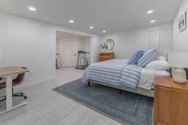 bedroom featuring baseboards, recessed lighting, and wood finished floors