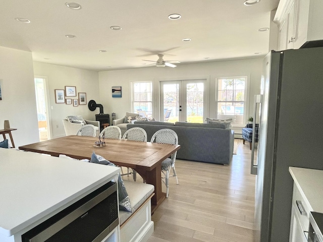 dining space featuring recessed lighting, a ceiling fan, french doors, and light wood-type flooring