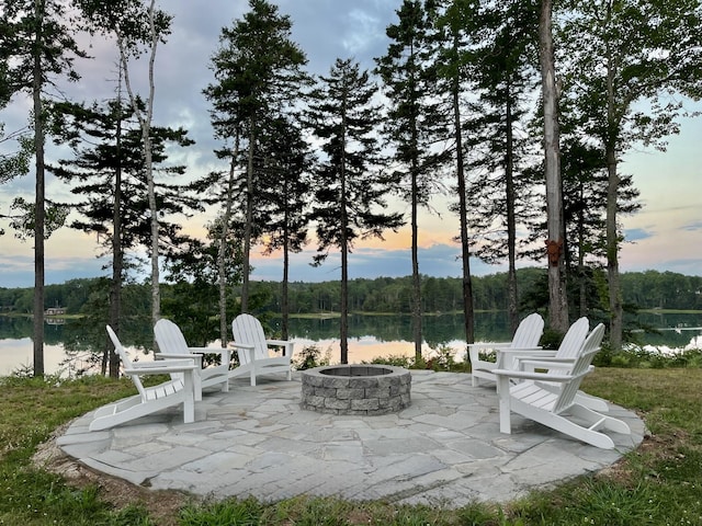 view of patio with a water view and a fire pit