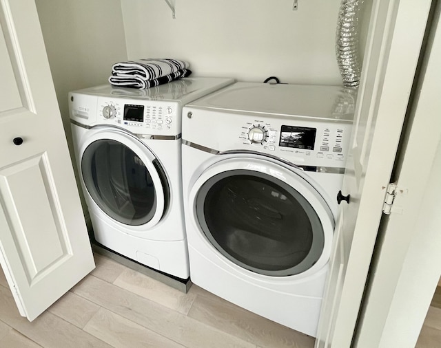 clothes washing area featuring independent washer and dryer and laundry area