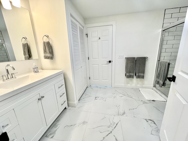 full bath with vanity, baseboards, a stall shower, and marble finish floor
